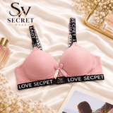 Love Secret Padded Bra in soft pink with smooth molded cups, black logo-print straps and band, and a satin bow.